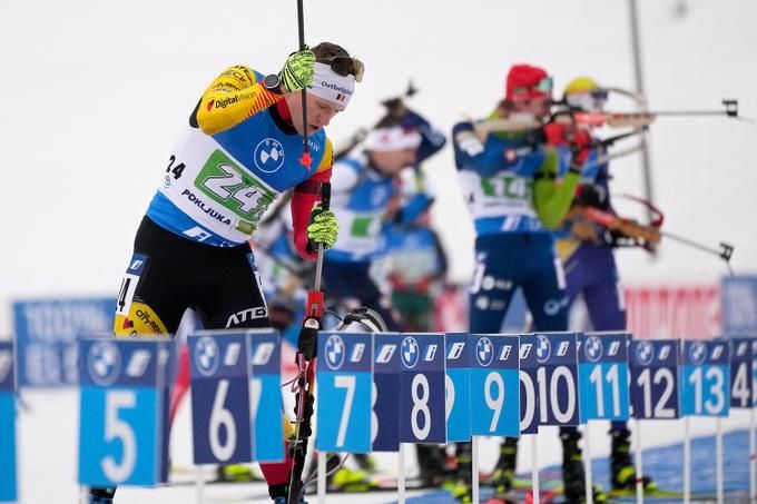 Belgian biathlete Langer points his rifle at his face during a World Cup race