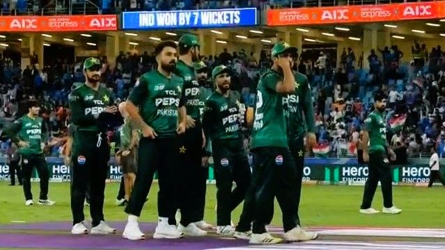Pakistan team waiting to shake hands with India players after the match.