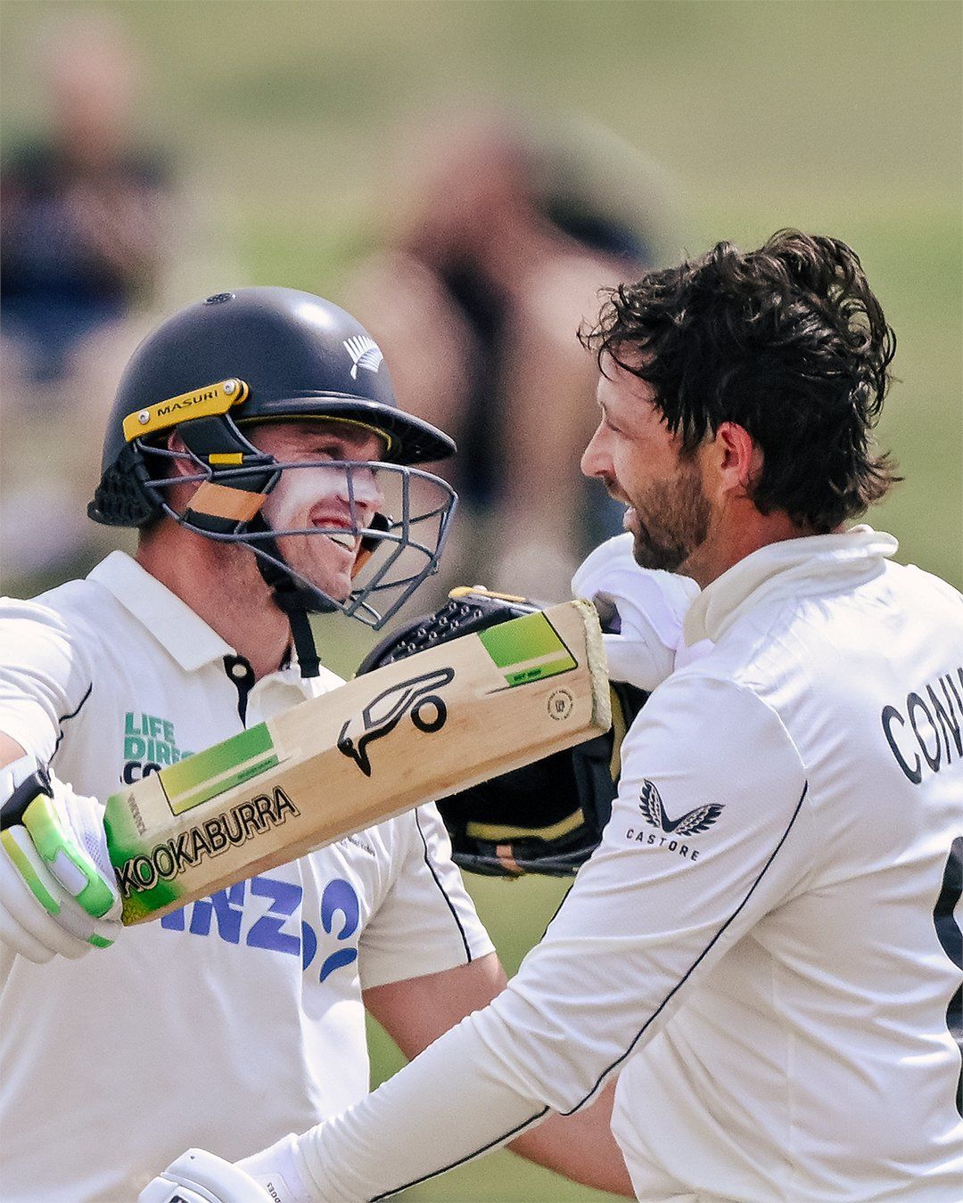 Devon Conway celebrates his ton with Tom Latham. @BLACKCAPS/X
