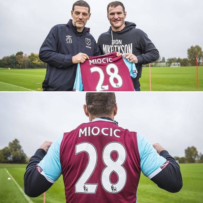 Stipe Miocic tried on a West Ham's T-shirt