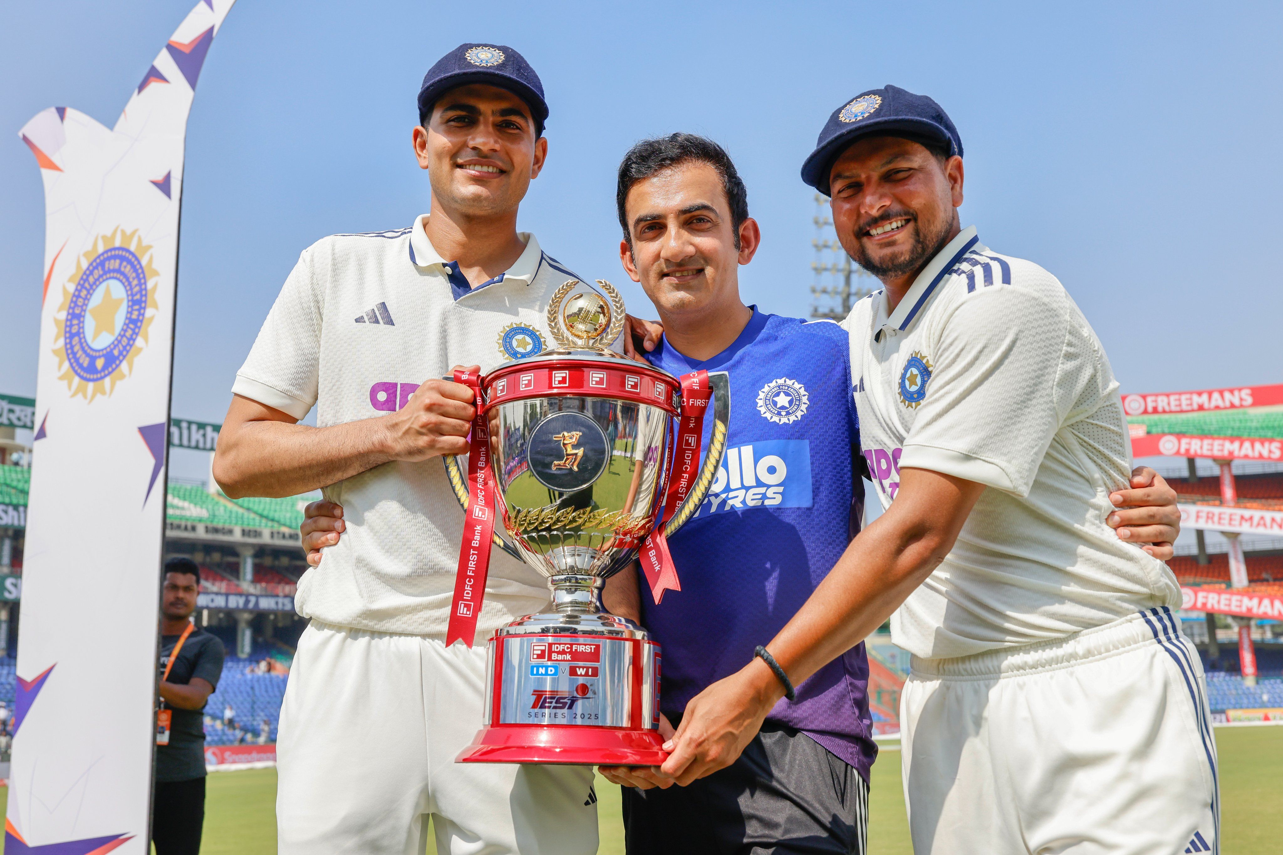Captain Shubman Gill, coach Gautam Gambhir and Kuldeep Yadav with the winners trophy. @BCCI/X