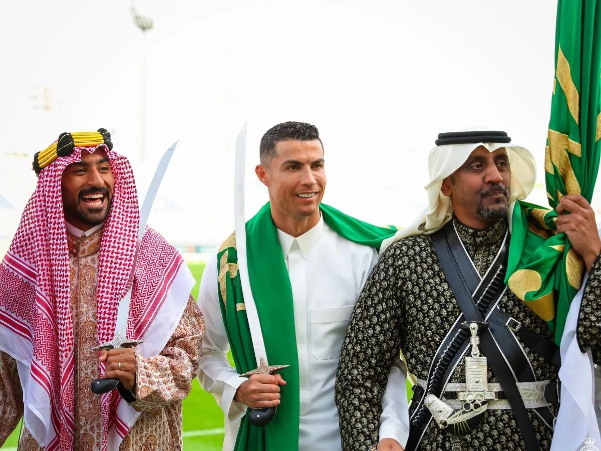 Ronaldo wearing a traditional shawl and holding a staff