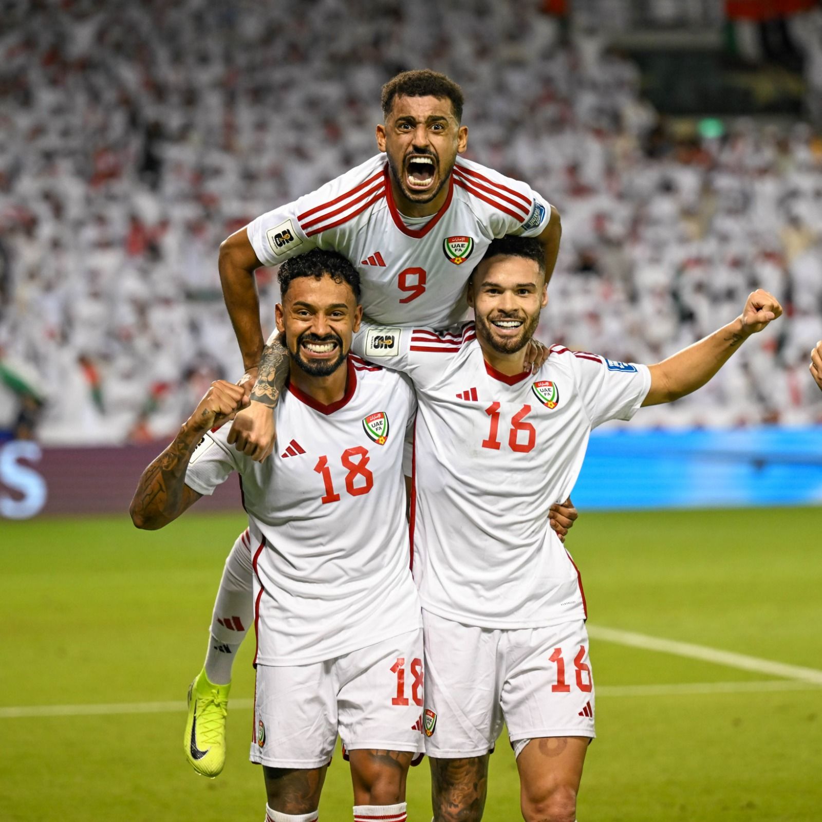 JUBILANT: UAE's Ciao Lucas (No. 16), Marcus Meloni and Harib Abdulla (top) celebrate their team's win over Oman in the fourth round Group A match of Asian Qualifiers at the Jassim Bin Hamad Stadium in Doha.