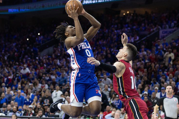 Tyrese Maxey contorts his body as Tyler Herro contests (Miami Heat vs Philadelphia 76ers)