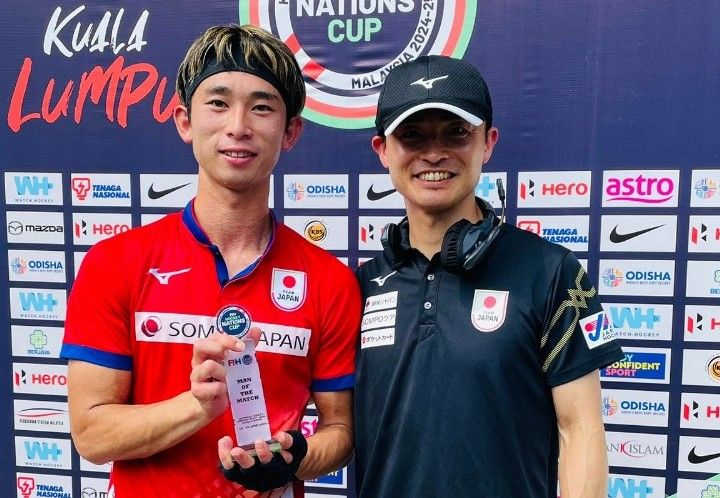 Japan striker Kosei Kawabe with assistant coach and manager Ippei Fujimoto.